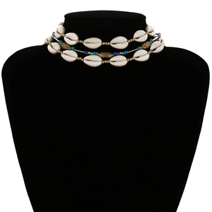 Multilayer bohemian shell necklace with turquoise beads and gold accents on black bust