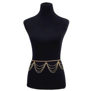 Chic multi-layered gold metal body chain with fringe pendants on black mannequin
