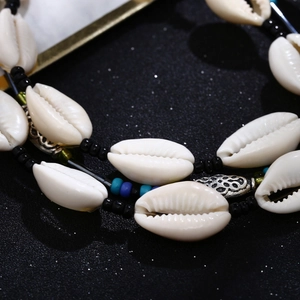 Detailed close-up of Hawaiian shell necklace with colorful beads and vintage silver accents