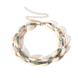 Detail of bohemian necklace showing natural white shells and gold lobster clasp