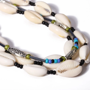 Handmade Bohemian necklace with shells, colorful beads, and vintage silver-carved tubes