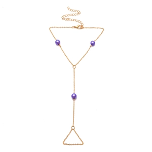 Cadena de mano dorada con elegantes perlas púrpuras y detalle de anillo bohemio