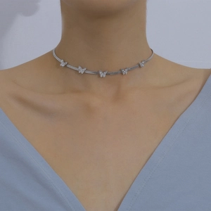 Detail of silver choker necklace featuring five butterfly pendants with pavé-set crystals