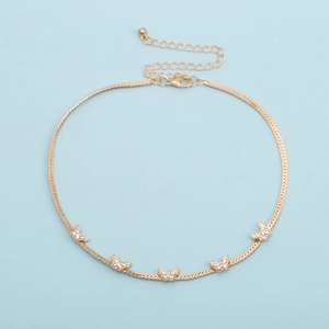 Detailed view of a gold snake chain necklace with five butterfly charms and zircons