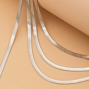 Detailed macro view showing the smooth texture and silver luster of flat herringbone chains