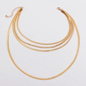 Detail of multi-layered gold snake chain necklace with lobster clasp and adjustable links