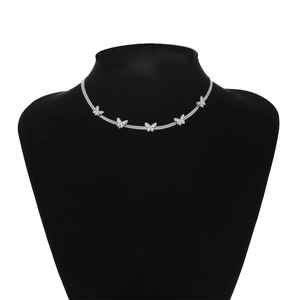 Close-up of silver snake chain necklace featuring five sparkling butterfly pendants