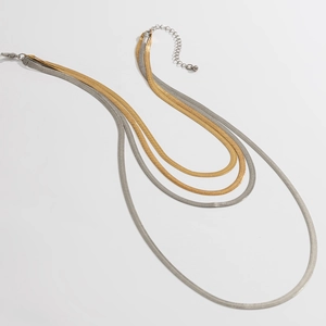 Detail of four-layer mixed gold and silver snake bone chain necklaces with lobster clasp