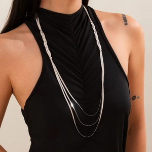 Close-up detail of layered punk snake bone necklaces and mixed chunky chain design