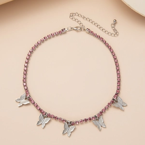 Detailed view of silver butterfly pendants and pink rhinestone chain with lobster clasp