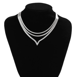 Detailed close-up of triple-layered silver snake chains with a V-shaped necklace design