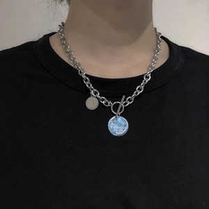 Detail of O-chain necklace with OT-bar clasp and engraved love story round pendants