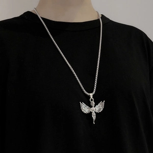 Detail of silver angel wing pendant on a chunky chain necklace for street style
