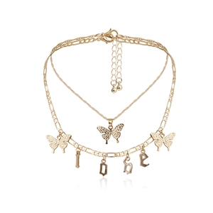 Detailed close-up of gold layered necklace with LOVE letters and butterfly charms