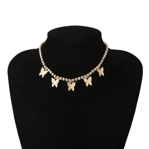 Detail view of a gold-toned choker necklace featuring sparkling rhinestones and five butterfly pendants