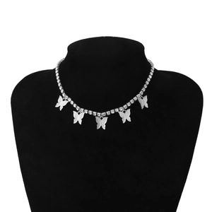 Macro shot of sparkling silver butterfly necklace with crystal pavé on black mannequin