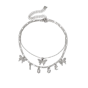 Detail view of double-layered butterfly choker featuring Figaro chain and letter pendants