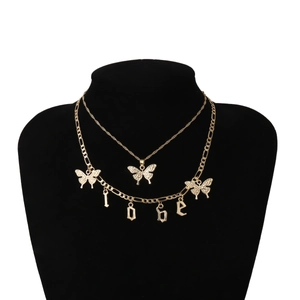 Close-up of gold layered necklace featuring hollow butterfly and LOVE charms on black bust