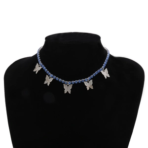 Detail of silver butterfly necklace with blue crystals and sparkling stones on model