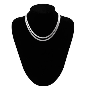Close-up of double-layer silver snake bone chain necklace on a black jewelry mannequin