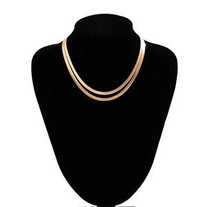 Detail of double-layered gold herringbone snake chain necklace on a black display bust