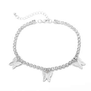 Detail of silver tennis chain with butterfly pendants and sparkling rhinestones close-up
