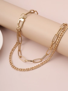 Golden layered paperclip and Cuban chain necklace with carabiner lock on display