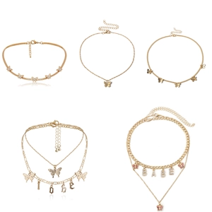 Minimalist gold butterfly necklaces and rhinestone letter pendants on a slim chain