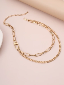 Detail of gold double layer paperclip chain necklace with carabiner lock and lobster clasp