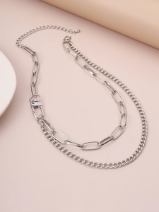 Detail view of double-layered silver chain necklace with a paperclip link and lobster clasp