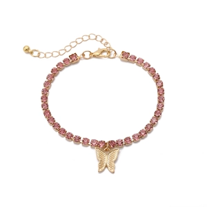 Detailed macro view of pink rhinestone necklace with gold butterfly pendant and lobster clasp