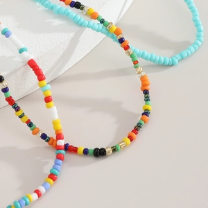 Macro shot of colorful bohemian handmade seed bead bracelet on textured white stone