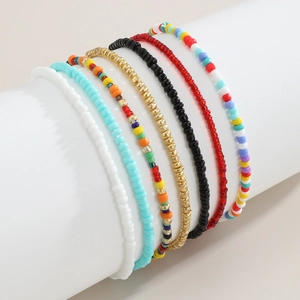 Detail of 7 bohemian handmade colorful beaded elastic bracelets on a display