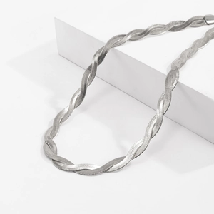 Detail view of twisted silver flat snake chain necklace with mirror-polished metallic finish