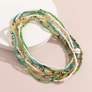 Detail of colorful beads and natural seashell pendant on bohemian summer body chain