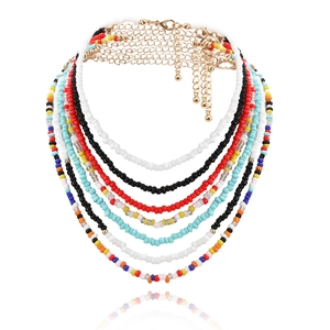 Detail of colorful multilayered beaded waist chain with gold lobster clasp and teardrop pendant