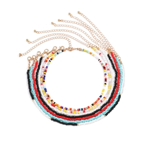 Detail of colorful seed bead body chains with gold lobster clasp and adjustable metal chain