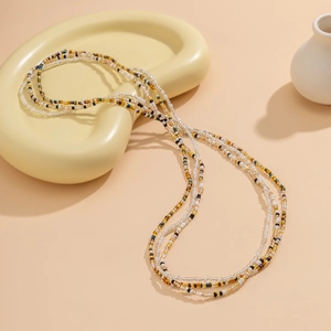 Detail view of multi-layered colorful seed bead waist chains with bohemian style design