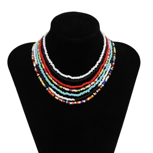 Detail of multi-layered colorful seed bead body chain on a black velvet jewelry display