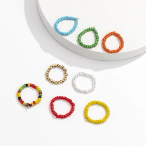 Macro shot of 8-piece set colorful beaded elastic rings with vibrant mixed boho patterns