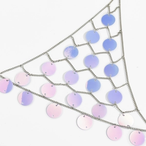 Detail of holographic sequins on silver mesh body chain for beach party wear
