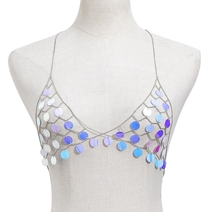 Detailed macro view of colorful iridescent sequins on silver metal chain body harness