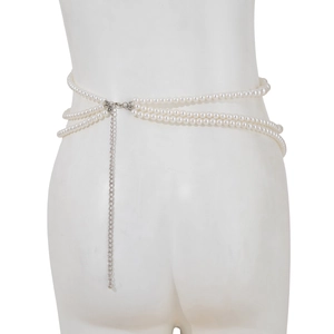 Detail shot of the three-layer white faux pearl waist chain with silver lobster clasp and chain