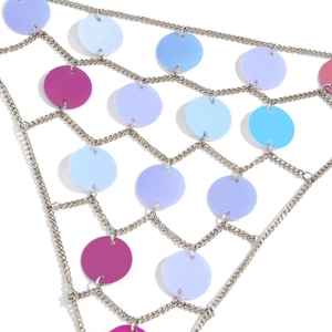 Macro detail of silver chain body jewelry with colorful sequins and diamond mesh design