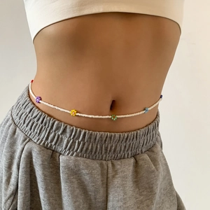 Detailed close-up of Bohemian handmade colorful seed bead waist chain with daisy flower patterns