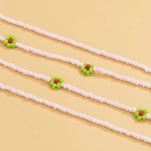 Close-up of bohemian pink seed bead body chain with handmade colorful floral patterns