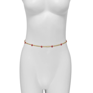 Detail of beaded daisy waist chain with golden seed beads and red flowers on a model