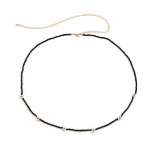 Detail view of Bohemian black seed bead waist chain with white daisy flowers and gold clasp