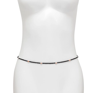 Detail of bohemian black seed bead waist chain with white daisy flowers on a mannequin
