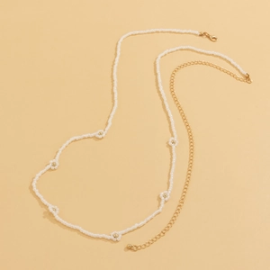 Close-up of bohemian beaded daisy chain necklace with gold clasp and extension links
